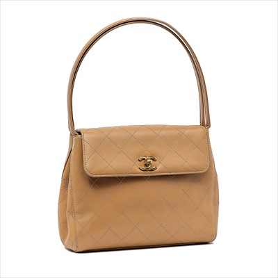 Lot 56 - Chanel - a beige leather handbag.