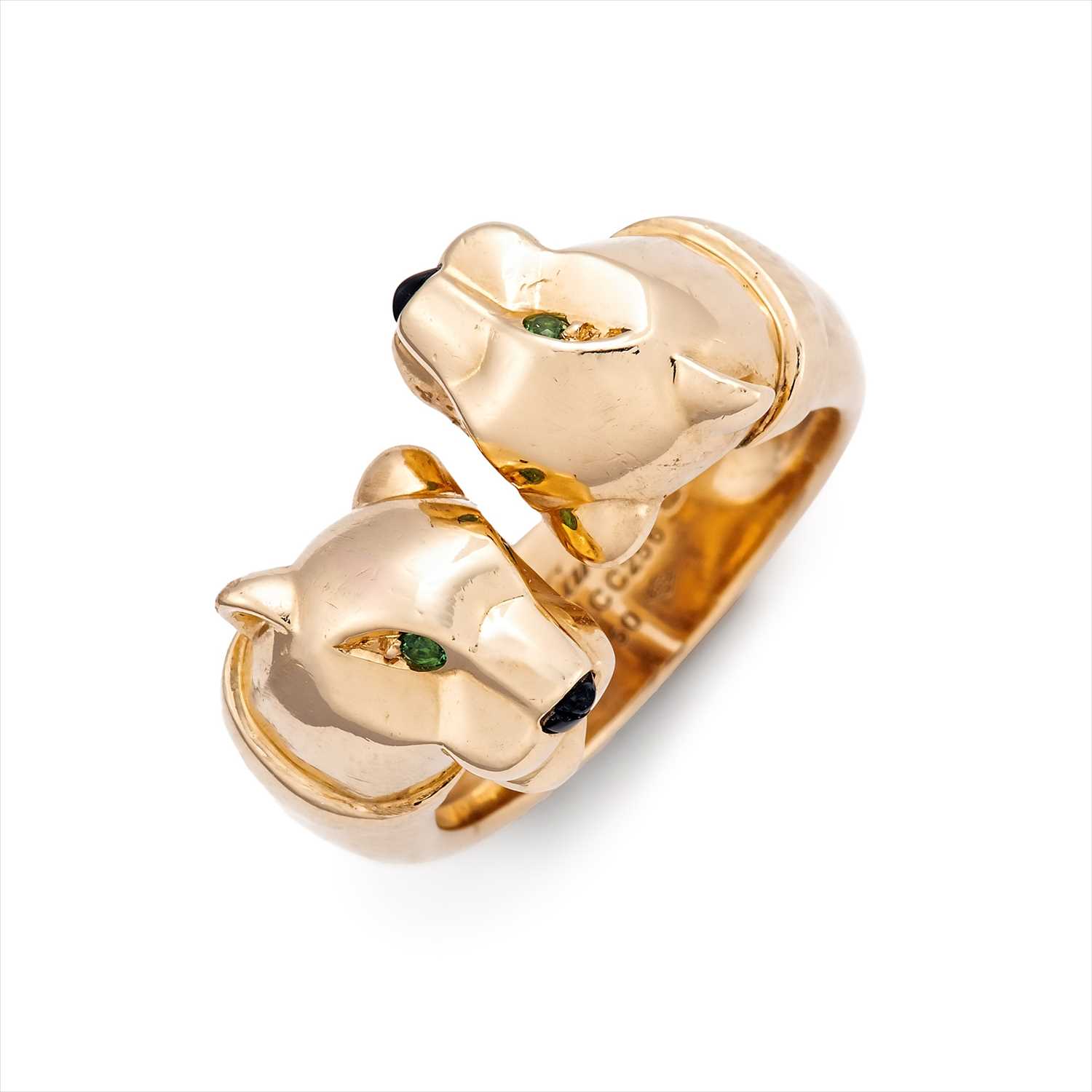 Lot 128 - Cartier - an 18ct gold onyx and tsavorite garnet Panthère ring.