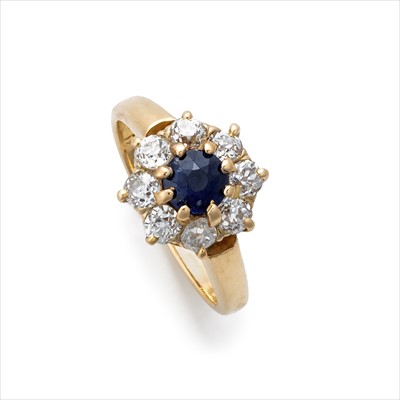 Lot 95 - A sapphire and diamond cluster ring.
